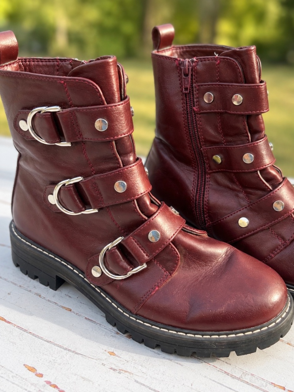 Burgundy moto-style ankle boots in women’s size 7